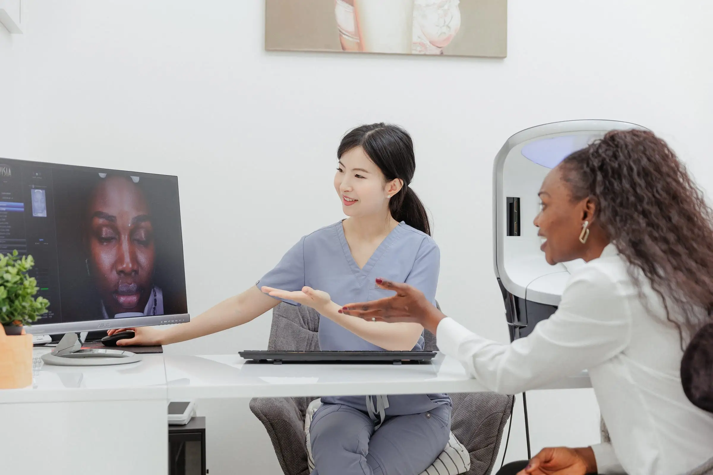 A nurse and a client reviewing skin imaging on screen at S.D. Medical Spa in Oakville.