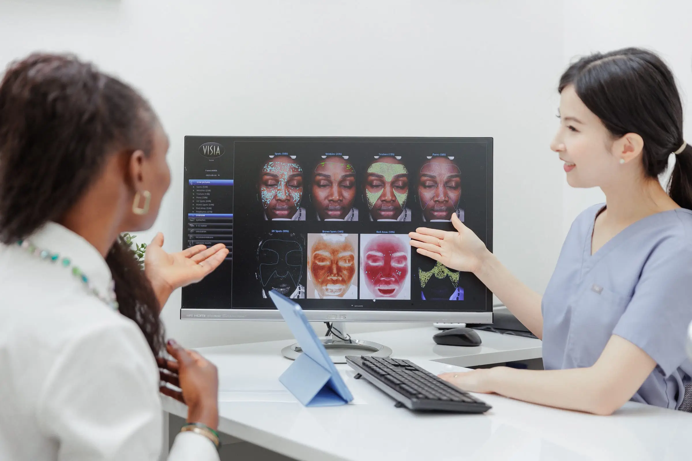 A nurse and a client reviewing skin analysis images on a screen at S.D. Medical Spa in Oakville.